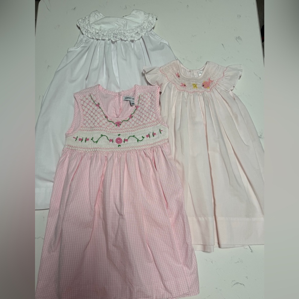 Lot if 3 dresses. Two smocked. Size 24 months, 18 months, 2T in GUC  pink white